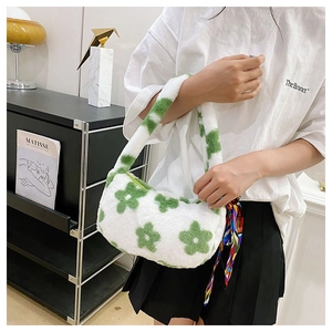 Detail of white plush shoulder bag featuring green flower pattern and colorful silk scarf decoration