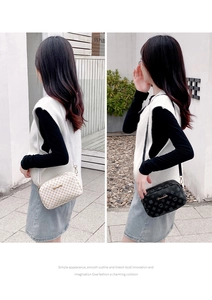 Detail view of stylish printed crossbody camera bags in white and black with metal logo
