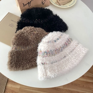 Detail of plush knitted hats in black, brown, and white with colorful speckled yarn texture
