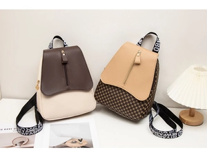 Detail view of stylish color-block backpacks with wide fabric straps and checkerboard pattern