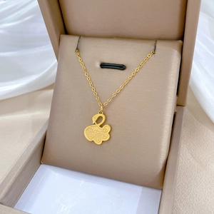 Gold swan pendant necklace in titanium steel displayed in a beige jewelry gift box