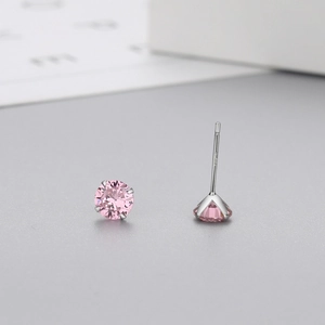 Macro detail of S925 sterling silver hallmark on pink zircon stud earrings with six-prong setting