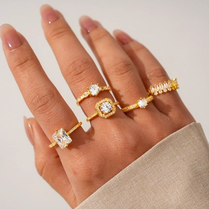 Close-up of five-piece gold-plated zircon ring set worn on a model's hand with luxury style