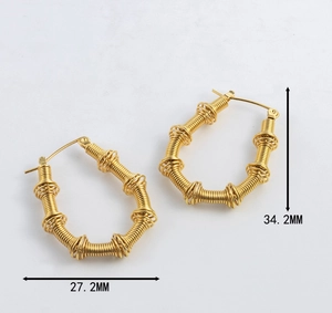 Detailed size view of twisted 18K gold earrings measuring 27.2mm wide and 34.2mm high