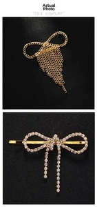 Detail of golden bow hair clips with rhinestone tassels and metal chains on black surface
