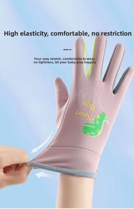 Detail showing the strong 4-way stretch material of kids pink dinosaur winter sport gloves