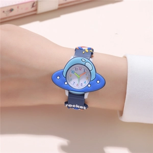 Close-up of kids quartz watch with blue UFO case and embossed rocket silicone strap