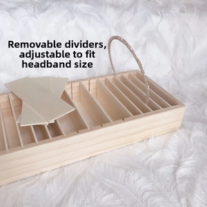 Detail view of wooden storage box with adjustable dividers for hairbands and jewelry