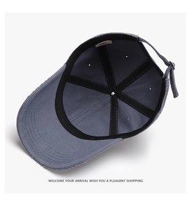 Detail view of washed cotton baseball cap showing distressed edges and inner stitching