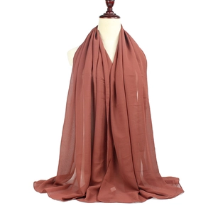 Detail view of burgundy chiffon hijab showing soft texture and lightweight drape on model