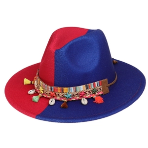 Detail of red and blue wool fedora hat featuring boho tassels and seashell trim