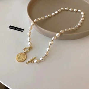 Baroque pearl necklace with T-bar clasp and vintage coin pendant in elegant French style