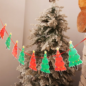 Detail of red and green Christmas tree paper bunting hanging in a cozy holiday scene