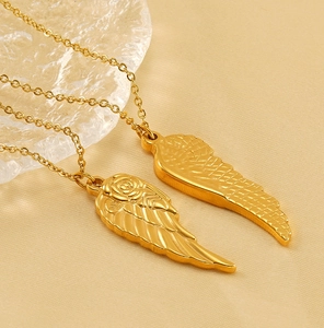 Detail of 18K gold plated angel wing pendant with delicate rose carving on O-chain
