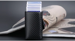 Detail view of carbon fiber RFID card holder with pop-up mechanism and weave pattern