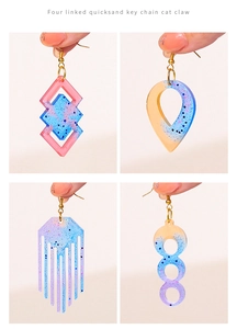 Macro detail of geometric resin earrings with pink, blue, and purple glitter effect