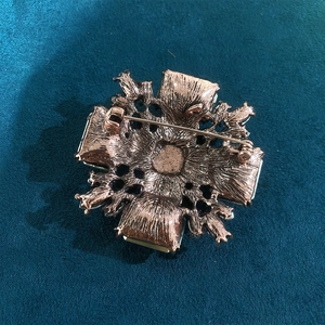 Vintage rose gold cross flower brooch with textured metal back and pin closure