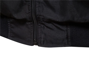 Detail shot of black casual jacket featuring resin zipper and elastic ribbed hem