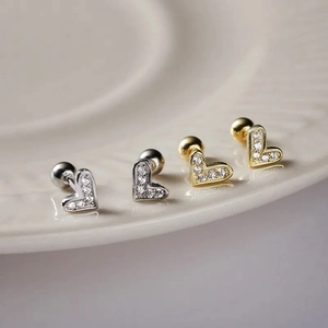 Elegant heart-shaped screw-back stud earrings in gold and silver with white zircon pavé
