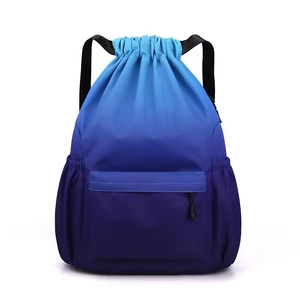 Dettaglio dello zaino blu sfumato con coulisse, tasca frontale e trama in nylon resistente