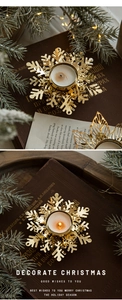 Macro view of golden snowflake iron candle holder with warm tea light for Christmas decor
