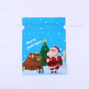 Detail of blue Christmas drawstring gift bag with Santa and Merry Christmas text