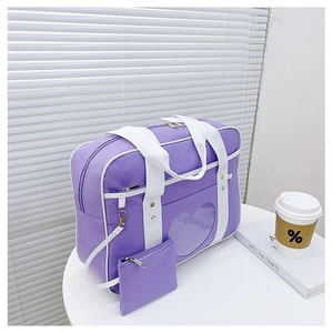 Detail of purple JK uniform bag with heart-shaped clear window and small coin purse