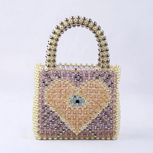 Luxury handmade colorful beaded handbag with heart pattern and blue flower on white background
