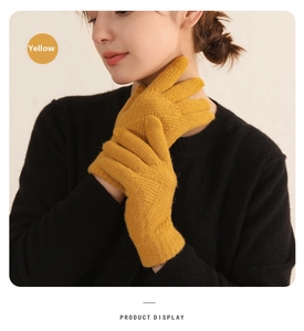 Detail of yellow knit winter glove showing the diamond texture and ribbed windproof cuff