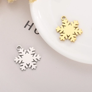 Close-up of gold and silver snowflake charms for DIY Christmas jewelry crafts