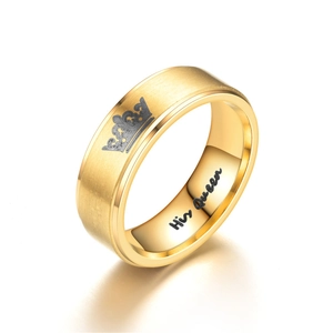 Detail view of gold ring with engraved crown and His Queen inner band