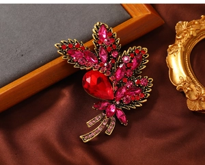 Macro shot of red and pink rhinestone floral brooch with vintage gold alloy carving