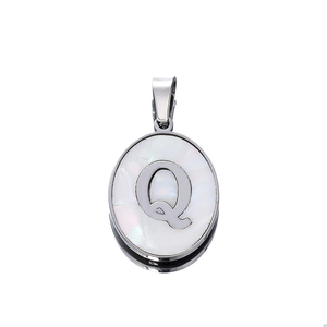 Macro view of oval letter Q pendant featuring white mother of pearl and silver steel frame