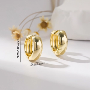 Detail view of 1.5cm wide gold hoop earrings showing product dimensions and texture