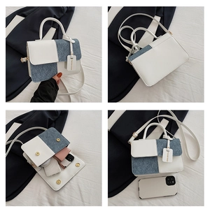 Detail view of denim and leather patchwork crossbody bag interior capacity with items