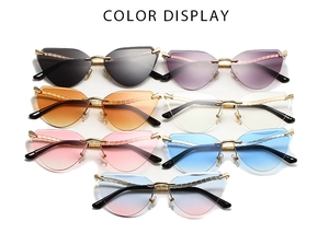 Detailed close-up of retro cat-eye sunglasses with colorful rimless lenses and gold metal frames