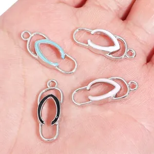 Set of four colorful flip-flop alloy charms for DIY jewelry making held in hand