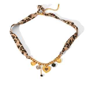 Detail of leopard print ribbon necklace with gold heart charms and black flower pendant