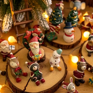 Miniature resin Christmas ornaments set with Santa, Snowman, and Reindeer on a wood base