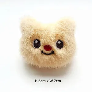 Close-up of cute plush bear accessory with embroidery detail, size 6cm by 7cm