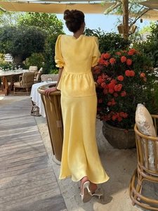 Pale yellow two-piece set with puff sleeve top and midi skirt in breathable cotton linen