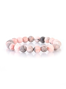 Macro detail of natural stone beaded bracelet with pink and grey marble texture on white background