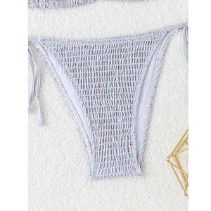Close-up of light blue floral bikini bottom with ruched texture and side tie strings