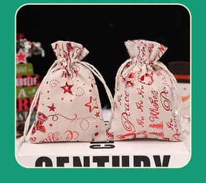 Detail of Christmas drawstring linen gift bags with gold foil reindeer and bell patterns