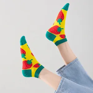 Women's yellow cotton socks with strawberry pattern and green contrast accents