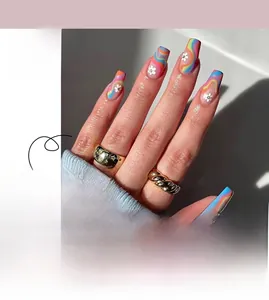 Macro shot of press-on nails featuring colorful wave lines and white flower accents