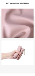 Detail showing the soft lychee grain pink leather and premium gold metal zipper of the wallet
