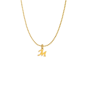 Detail shot of golden M letter pendant with elegant beaded chain on white background