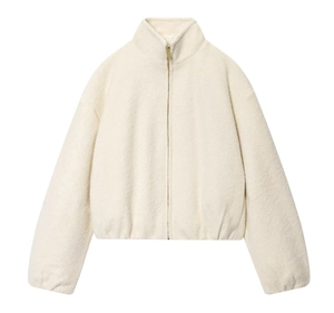 Detail of cream standing collar fleece jacket with golden zipper and textured fabric