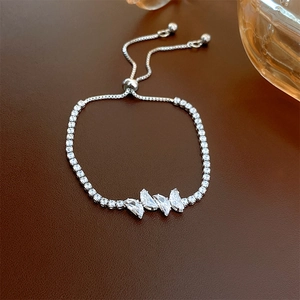 Detailed macro view of silver zircon butterfly bracelet with adjustable bolo clasp